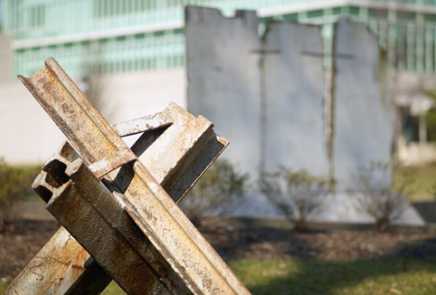 Stacked pieces of metal, with the back of the monument visible in the background.